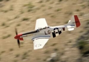Tom Cruise’s P-51 Mustang, a polished vintage fighter plane, used in Top Gun: Maverick, reflecting his aviation passion.