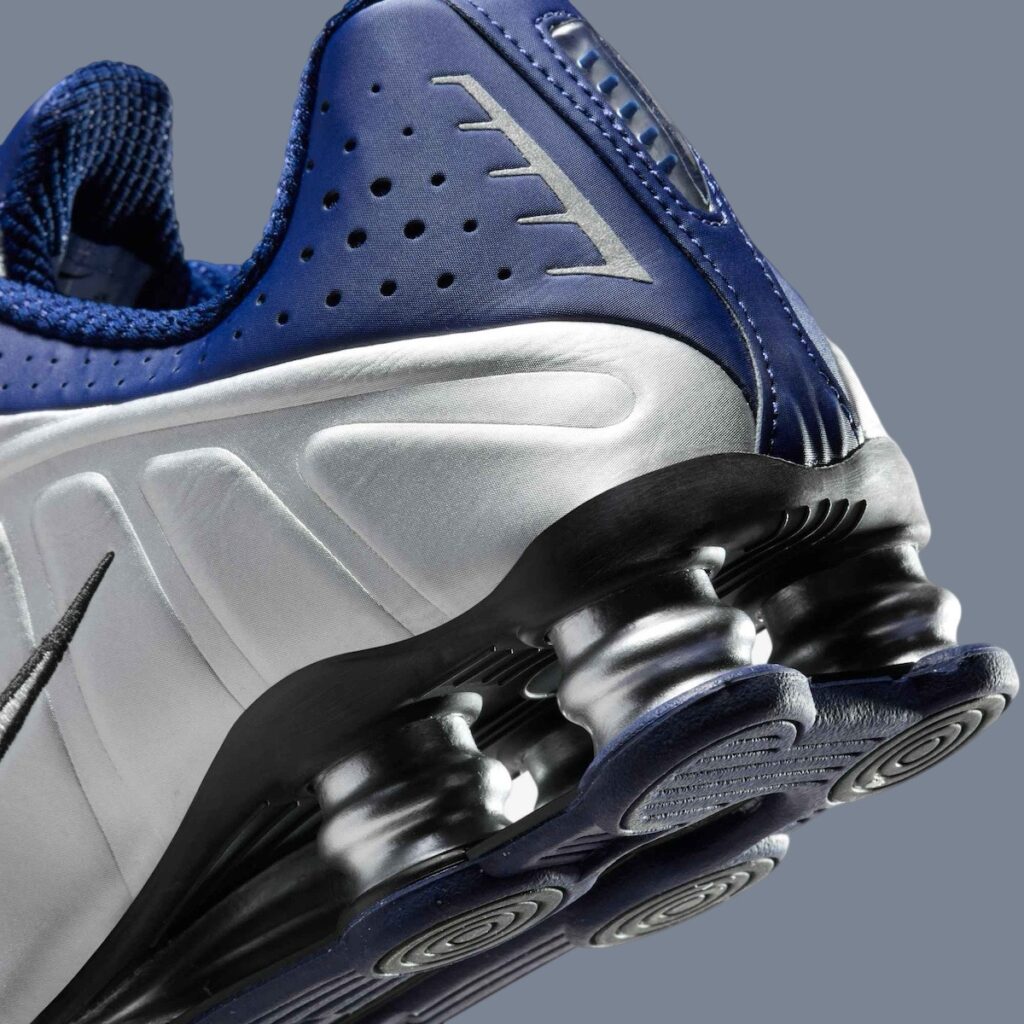 “Nike Shox R4 Blue Void sneakers featuring metallic silver accents, vivid blue Shox columns, and a futuristic design.”