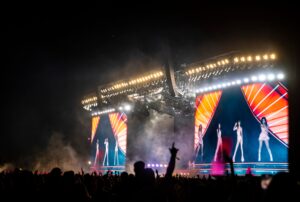 “Coachella 2025 lineup poster featuring headliners Lady Gaga, Post Malone, Green Day, and Travis Scott with festival dates and location.”