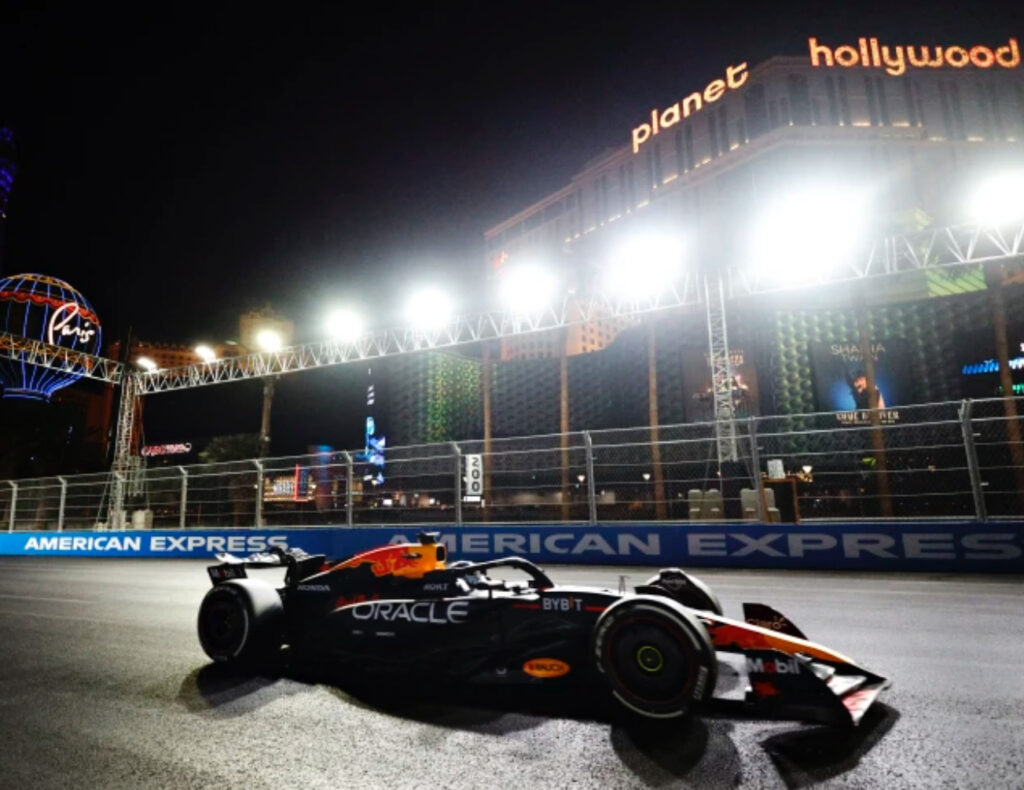 Max Verstappen celebrates clinching his fourth Formula 1 world championship at the Las Vegas Grand Prix under dazzling lights.