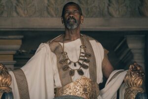 Denzel Washington as Macrinus in Gladiator II, portraying a complex and ambitious character inspired by Roman history.
