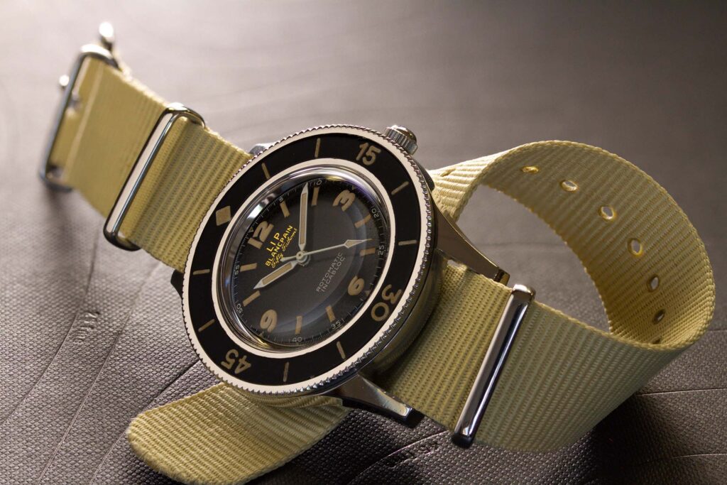 Close-up of the Blancpain Fifty Fathoms dive watch, showcasing its intricate movement and detailed craftsmanship during deconstruction.