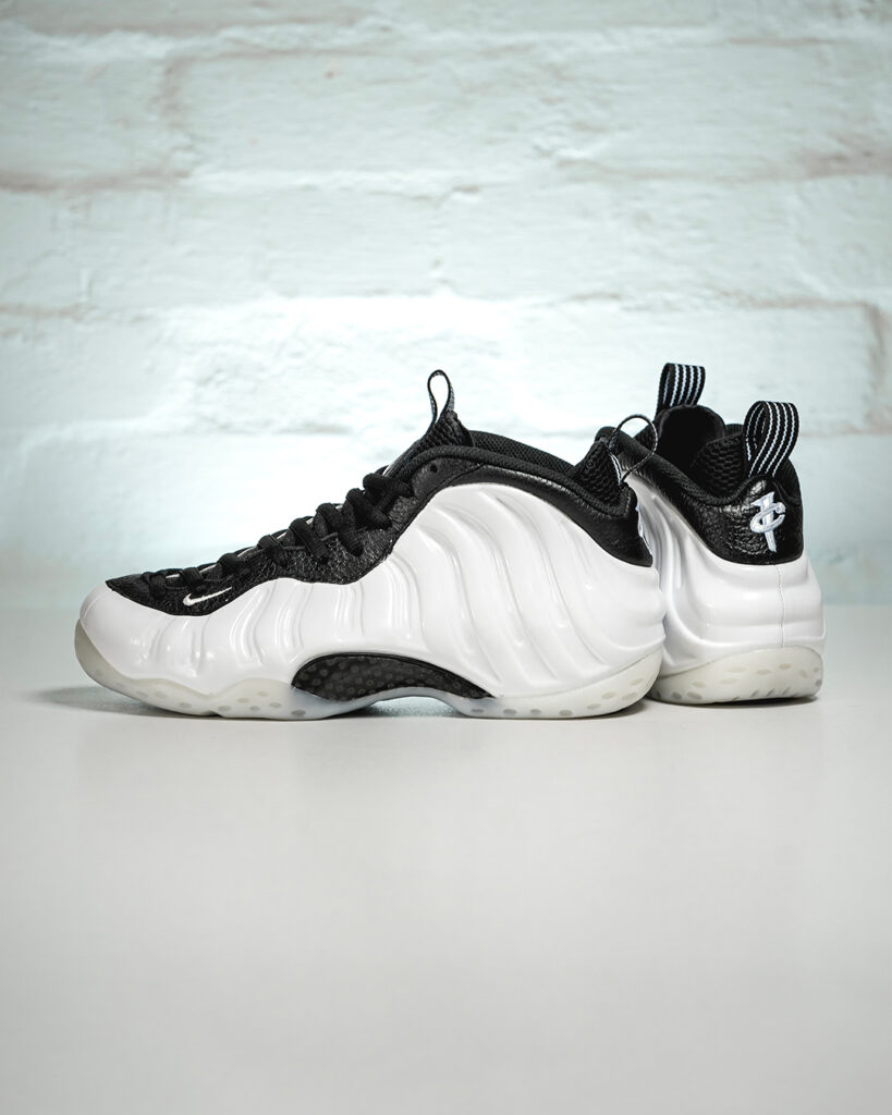 Nike Air Foamposite Pro “Pearl” sneaker featuring a shimmering white Foamposite upper with black accents and silver Swoosh logo.