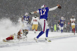 Buffalo Bills quarterback Josh Allen celebrates after making NFL history with passing, rushing, and receiving touchdowns.