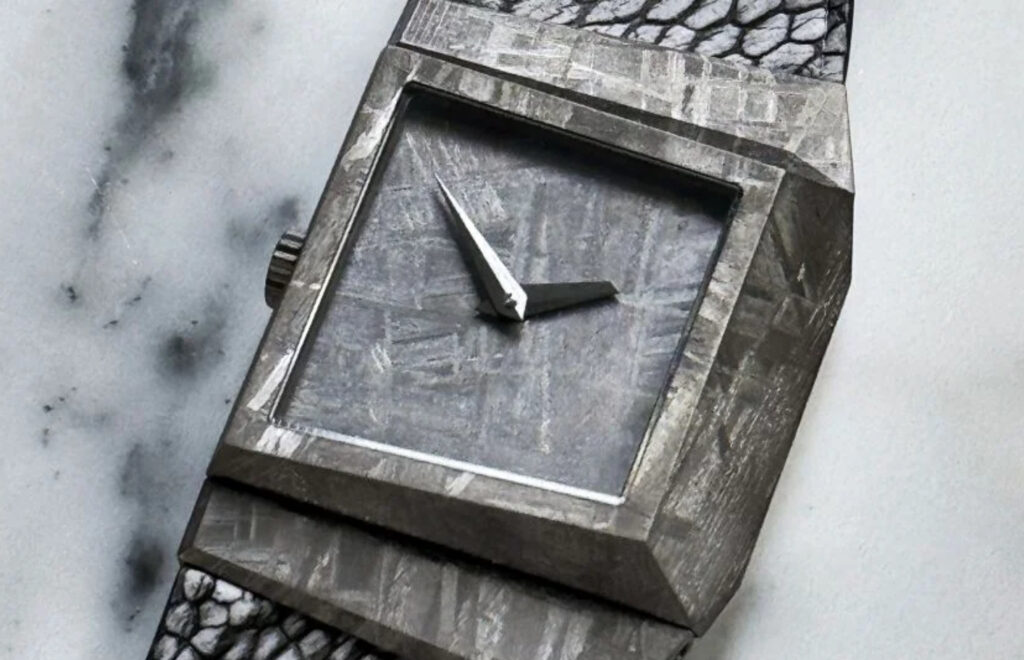 “A luxurious watch with a meteorite dial, showcasing the unique Widmanstätten pattern, carved from a million-year-old meteorite.”
