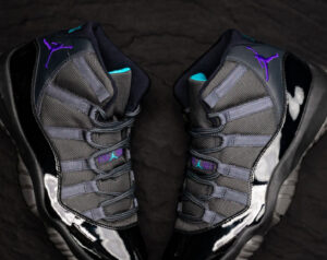 Air Jordan 11 “Gamma Blue” featuring a sleek black upper, gamma blue accents, and varsity maize detailing for a bold look.
