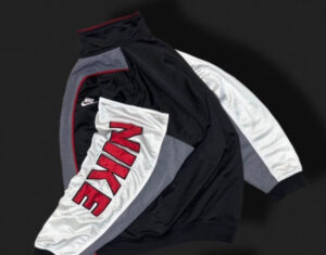 90s Nike vintage tracksuit long-sleeve featuring an oversized swoosh logo, bold color-blocking, and relaxed fit design.
