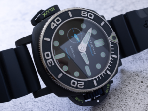 A modern Submersible Elux LAB-ID watch with luminous hands and indexes, glowing in the dark, showcasing cutting-edge design