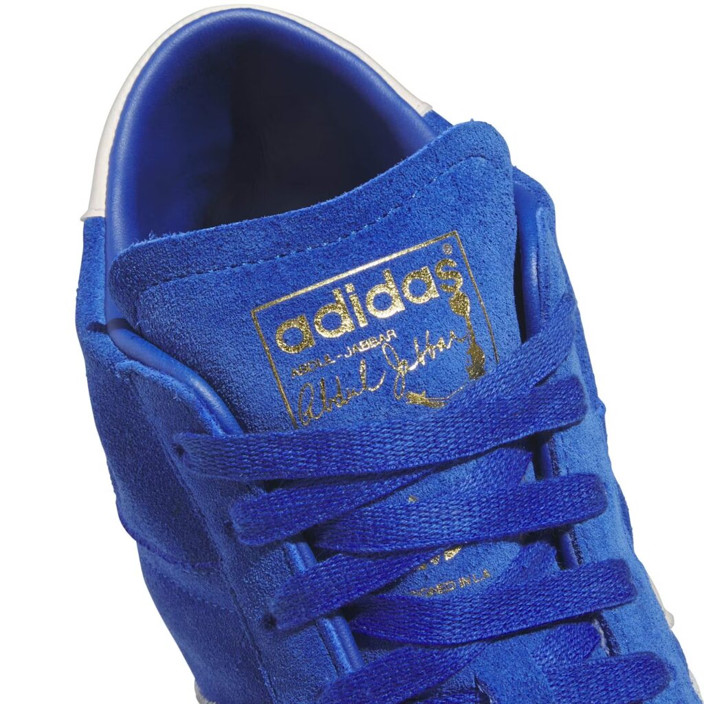 Adidas Jabbar OG sneaker in white leather with collegiate blue stripes, honoring Kareem Abdul-Jabbar’s legacy and style.