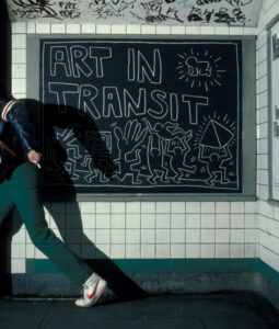 Keith Haring subway drawing featuring bold lines and iconic symbols, showcasing his vibrant style and universal themes