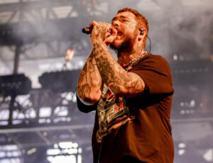 Post Malone performing live during his 2024 world tour, celebrating his placement as No. 9 on Billboard’s Top 10 Artists list