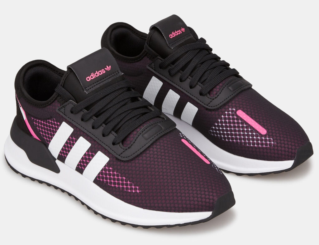 A sleek Adidas ultra-flat sneaker with a minimalist silhouette, featuring updated materials and vibrant color accents.