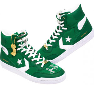 Larry Bird Converse sneakers in Boston Celtics colors, featuring a green and white leather design with retro-inspired detailing and a sleek reflective finish, paying homage to the basketball legend’s legacy