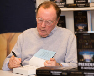 Alt Text: James Patterson addressing independent bookstore employees, highlighting his $500 holiday bonus initiative to support booksellers