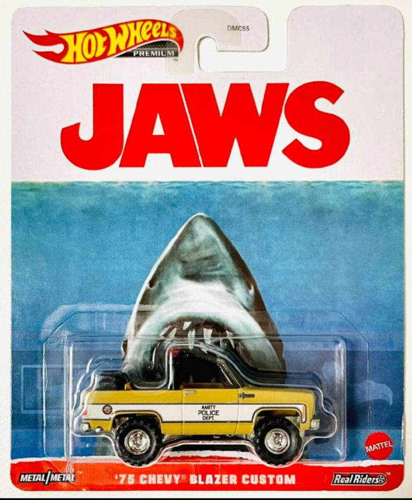 A Hot Wheels die-cast model of the 1975 Chevy Blazer from Jaws, capturing its rugged design and iconic film details
