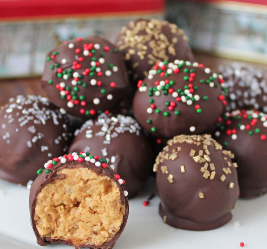 Peanut Butter Balls coated in chocolate and topped with sprinkles, perfect for the holiday season and easy to make