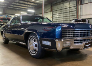 A sleek 1967 Cadillac Eldorado with a fastback roofline and hidden headlights, showcasing its elegant and angular design