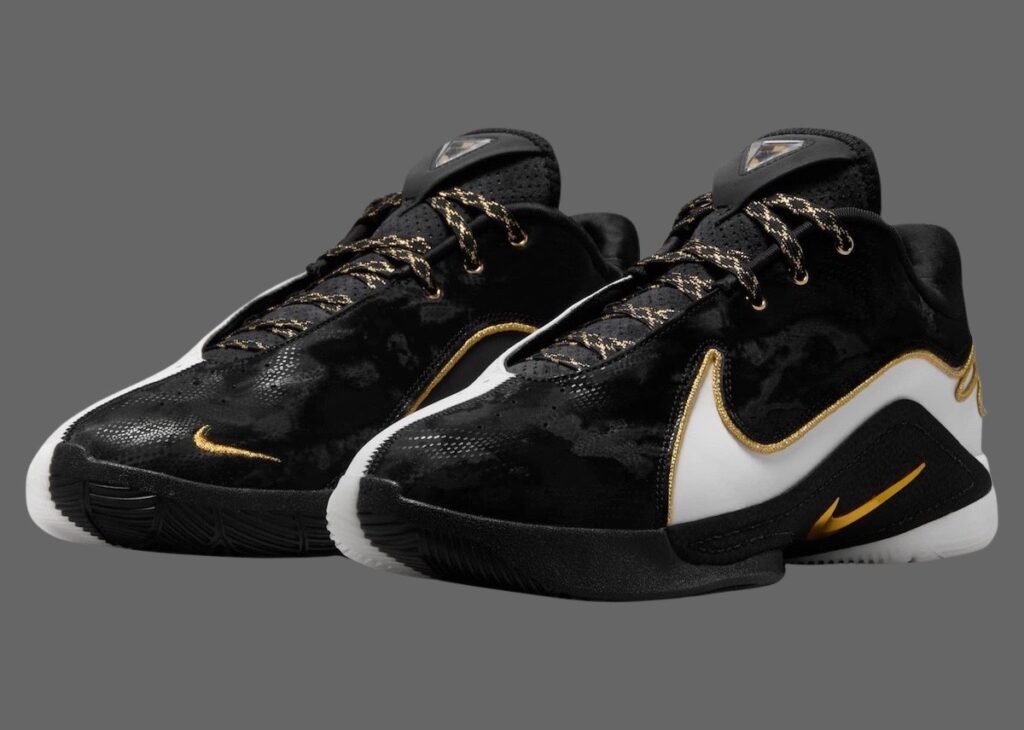 A close-up of the Nike LeBron 22 “Mogul” sneaker in burgundy and gold, showcasing its luxurious design and performance features