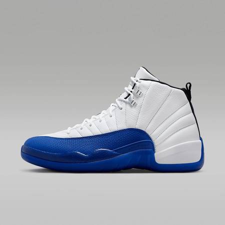 The Air Jordan 12 “White/Game Royal” featuring white tumbled leather with bold blue accents and faux reptile-textured mudguard