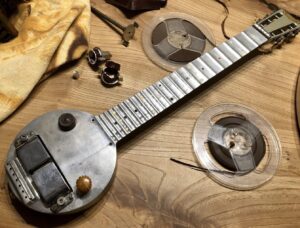 The Rickenbacker Electro A-22 “Frying Pan” guitar, a circular-bodied lap steel guitar made of cast aluminum with a long neck and a horseshoe magnet pickup, known as the first commercially successful electric guitar from the 1930s