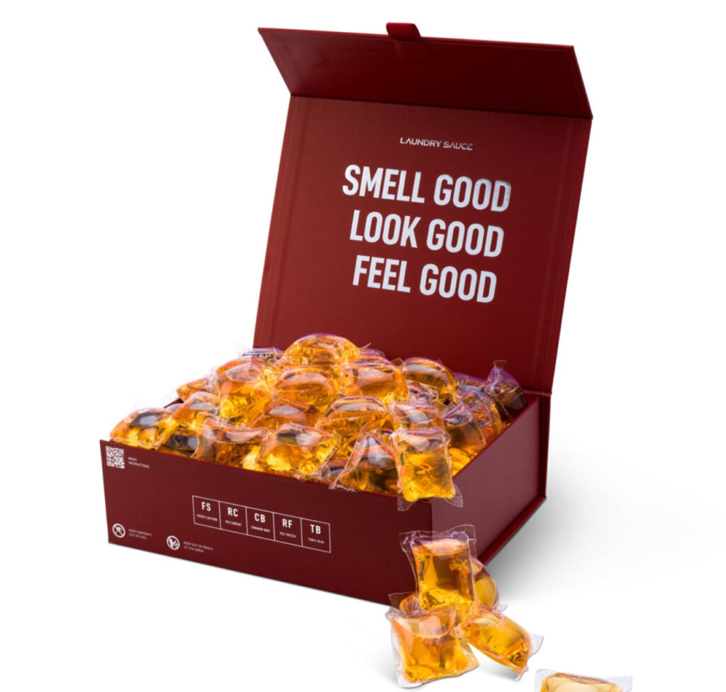 Luxury Laundry Sauce Detergent Pods with premium fragrances like Italian Bergamot and Siberian Pine on a stylish countertop