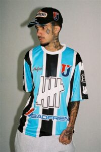 UNDEFEATED x Badfriend collaboration showcasing LA-inspired football jerseys, graphic tees, and stylish headwear