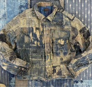 KAPITAL denim jacket with traditional Japanese boro patchwork, indigo dye, and hand-stitched detailing, symbolizing artisanal heritage