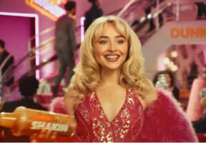 Sabrina Carpenter holding a Dunkin’ drink, showcasing her espresso collaboration featuring brown sugar and oat milk