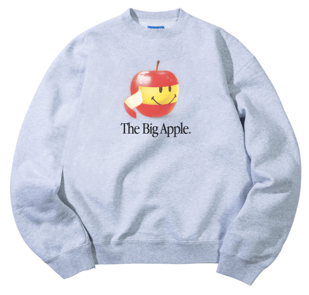 Smiley Big Apple Crewneck featuring a red apple design with a smiley face and the phrase “You’re the Big Apple of My Eye.”