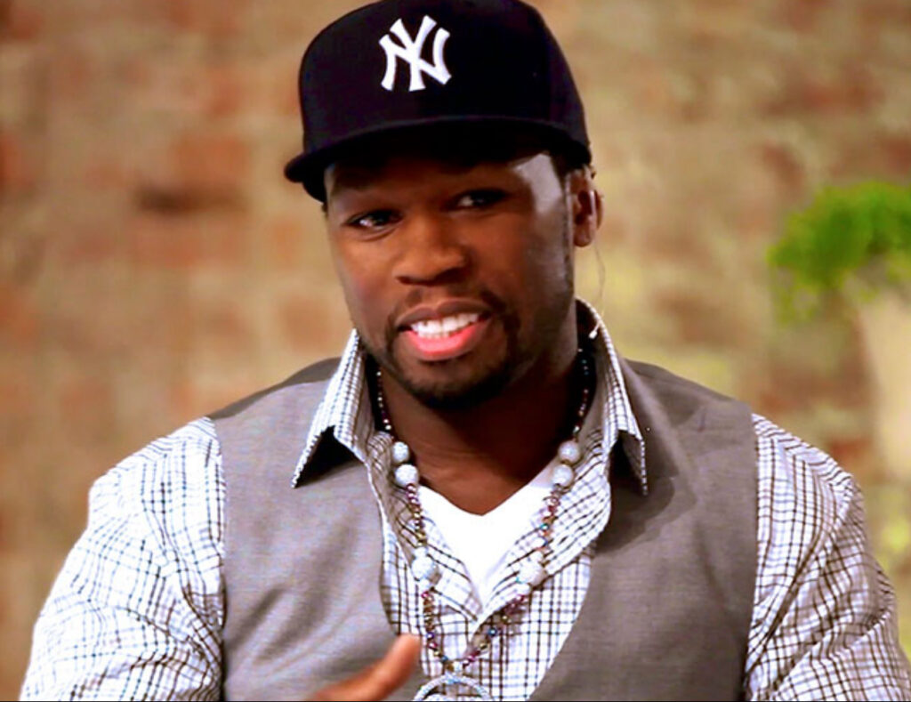 Curtis “50 Cent” Jackson speaking at a community event, highlighting his role as a philanthropist and cultural influencer