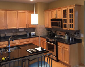 90s kitchen with honey oak cabinets, patterned tiles, and bold accents, blending nostalgic charm with modern updates