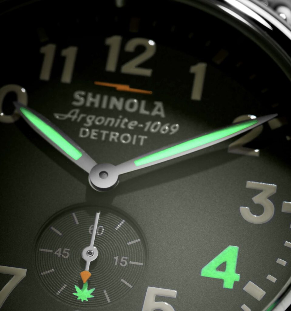 The Grassland Runwell watch with intricate cannabis leaf motifs, green and gold accents, and a sustainable strap design