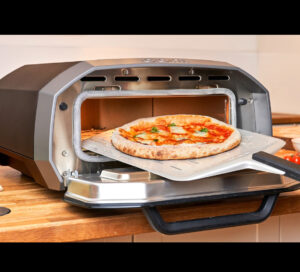 A sleek, smart electric pizza oven designed for apartment living, making restaurant-quality pizza on a countertop