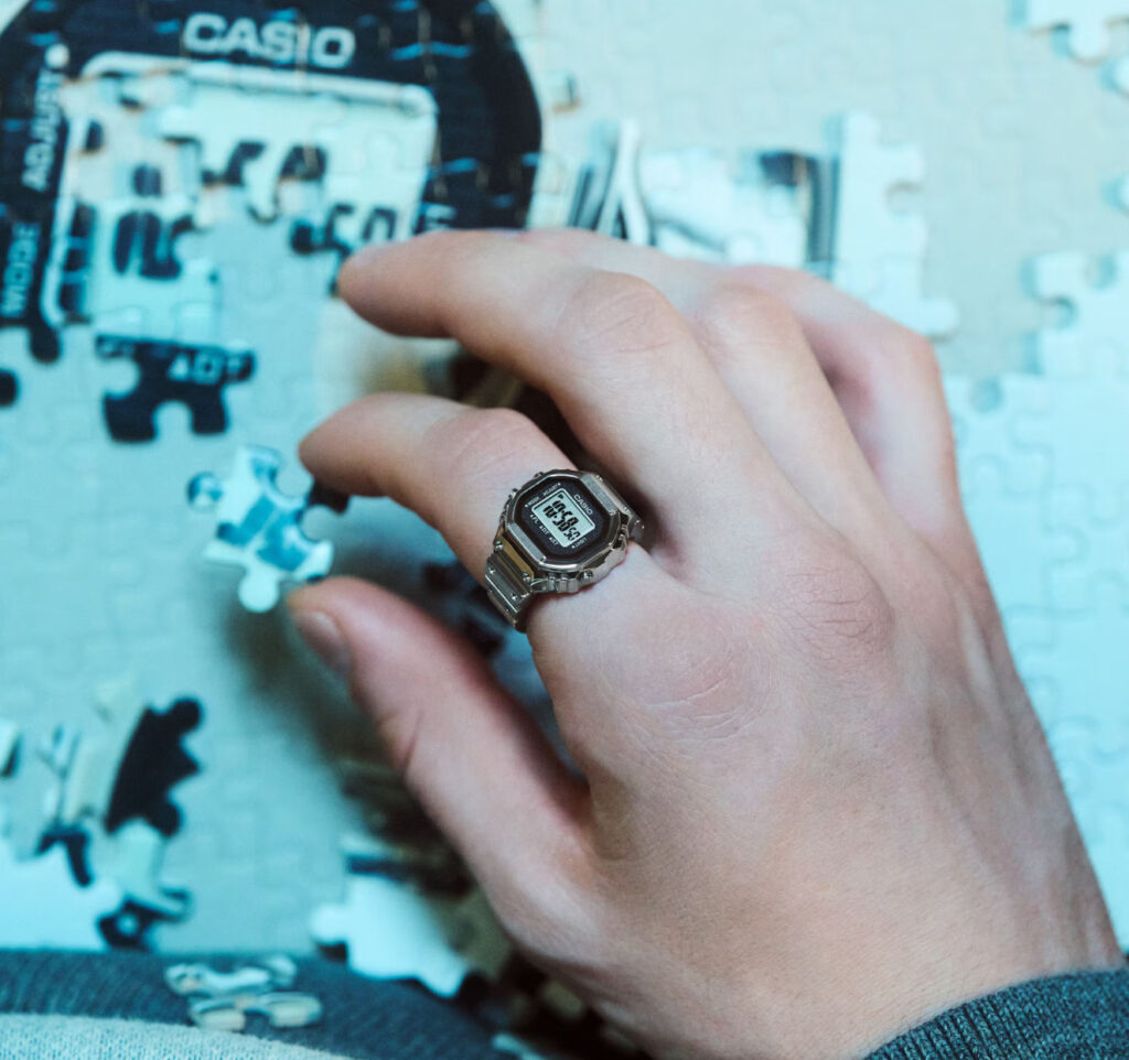 Casio CRW-001 Ring Watch showcasing its holographic display and gesture control features on a modern titanium design