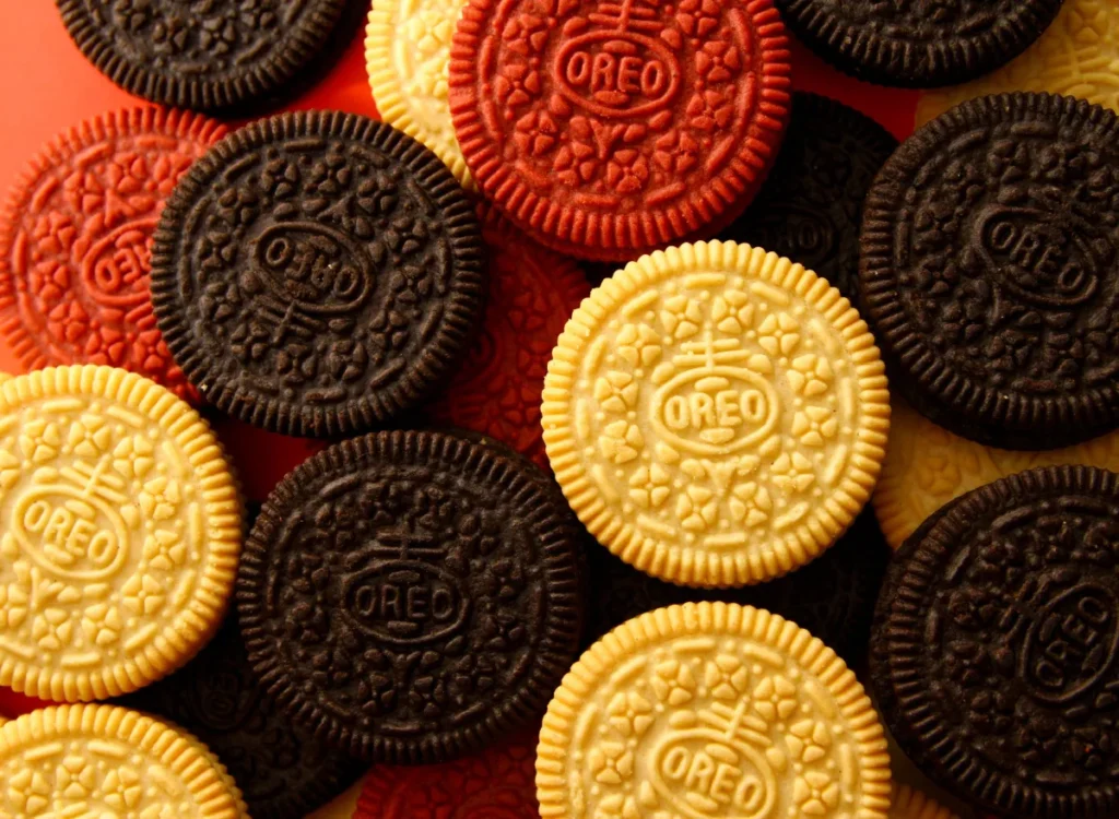 A stack of colorful, imaginative Oreo cookies in unique flavors, including Maple Bacon, Churro, and Key Lime Pie