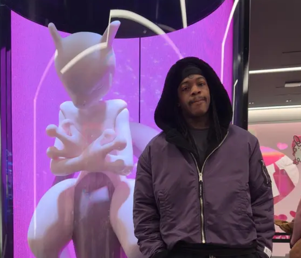 Thouxanbansauni bold streetwear posing under neon lights, symbolizing modern underground music and fashion culture
