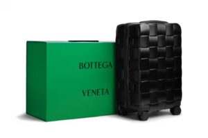 Bottega Veneta Odyssey suitcase with 3D Intreccio pattern, calfskin leather handles, and minimalist luxury design