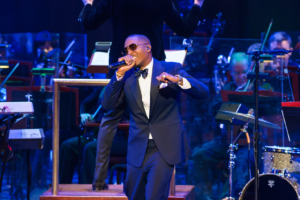 Nas performing live with the Las Vegas Philharmonic at Encore Theater, blending hip-hop storytelling with orchestral sounds