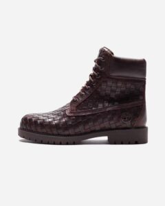 A pair of Timberland x Bottega Veneta boots featuring premium leather, intrecciato weave details, and a sleek modern design