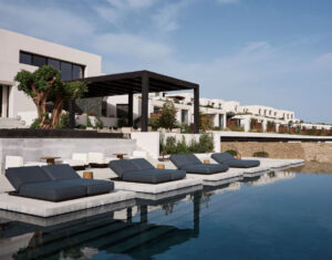 Exterior of Odera Hotel in Tinos, featuring locally sourced stone walls, marble accents, and a serene Cycladic landscape