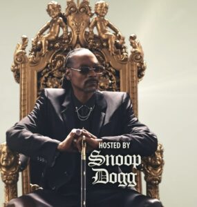 Snoop Dogg on stage, dressed stylishly, hosting the NFL Honors 2025 and engaging with the audience
