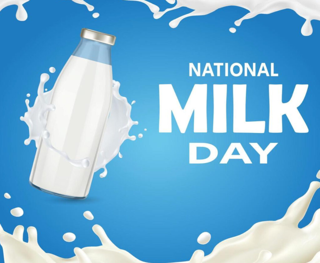 A glass of fresh milk with dairy farm scenery in the background, symbolizing National Milk Day and its significance