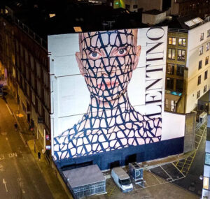 Valentino’s Toile Iconographe print painted on Kristen McMenamy’s skin, showcasing a bold blend of fashion and art