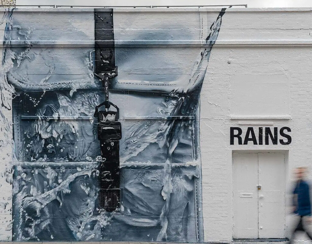 Hand-painted mural of the iconic Rains backpack on the Great Eastern Gallery Wall in Shoreditch, near Spitalfields