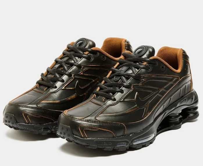 Close-up of the Nike Shox Ride 2 in premium leather, showcasing its iconic Shox columns and sleek British tan design