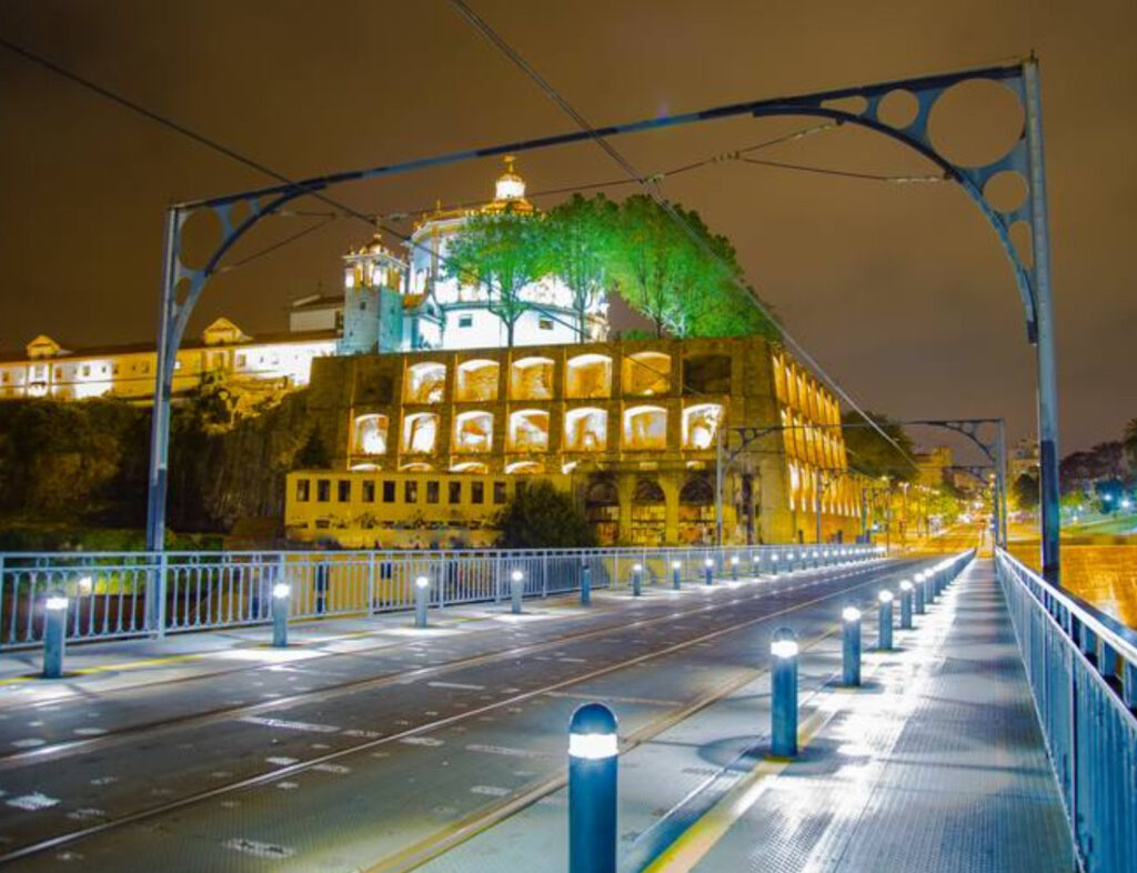 A stunning artwork of Porto at night, showcasing illuminated city buildings, the Douro River, and the iconic Dom Luís I Bridge