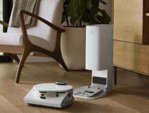 Robovac equipped with pincers picking up a sock while navigating an uneven floor with its climbing legs