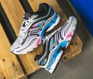 The Saucony ProGrid Omni 9 White/Multi, a stylish running shoe featuring vibrant accents and advanced stability support