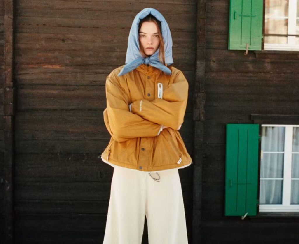 An assortment of winter apparel from the and wander x Zara collection, featuring jackets, fleeces, and accessories inspired by snowy landscapes