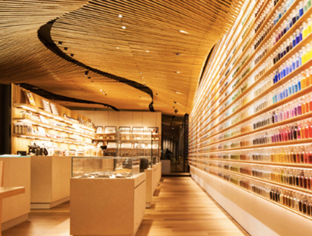 Interior of PIGMENT TOKYO showcasing shelves filled with vibrant pigments, traditional art tools, and a creative workspace